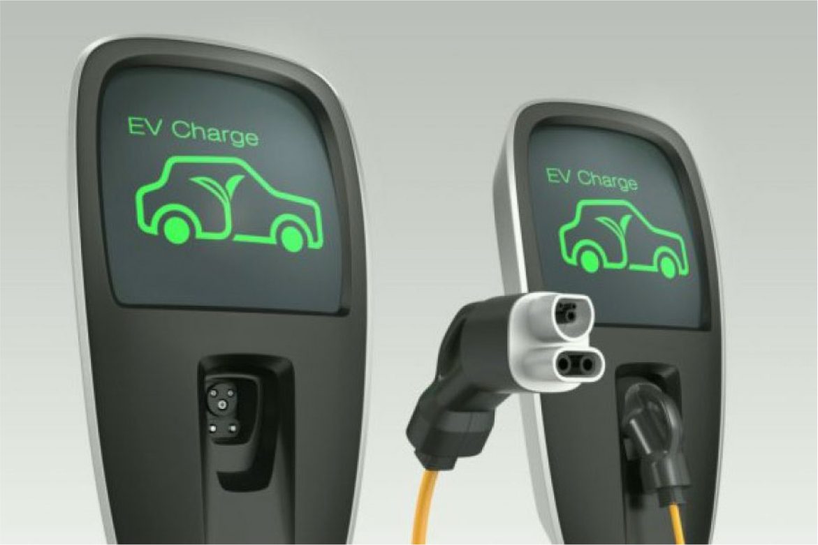 Two electric cars are plugged in to charge.